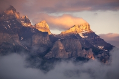 Fog and light meet at the face of Mt Rundle at sunrise, Canmore, Alberta, Canada