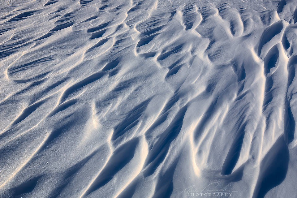 Wind carved snow patterns in afternoon side lighting, Banff National Park, Alberta, Canada