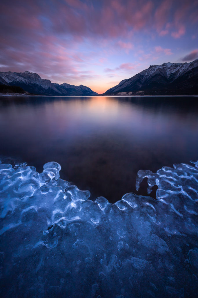 An icy focus stacked foreground at sunrise on Abraham Lake, Kootenay Plains, Alberta, Canada